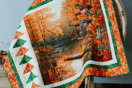 Finished quilt featuring a printed autumn duck fabric panel.
